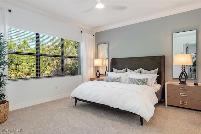 bedroom featuring crown molding, ceiling fan, and light carpet