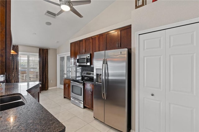 kitchen with lofted ceiling, ceiling fan, light tile patterned flooring, stainless steel appliances, and visible vents