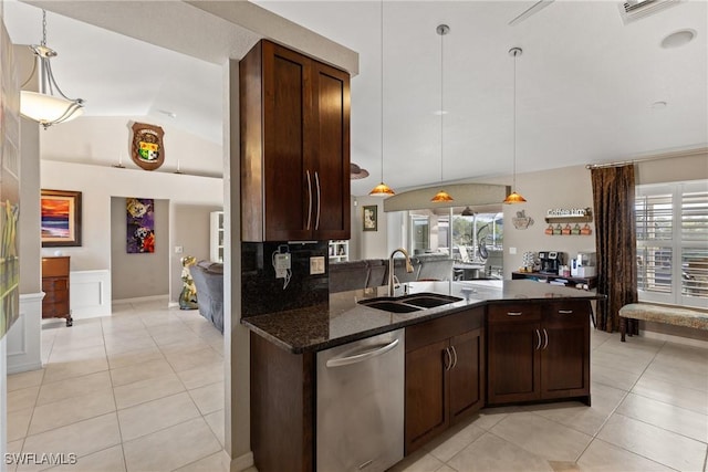 kitchen with decorative light fixtures, lofted ceiling, a sink, dark stone countertops, and dishwasher