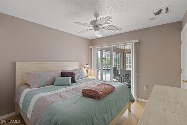 bedroom with visible vents, a ceiling fan, light wood-style flooring, access to outside, and a textured ceiling