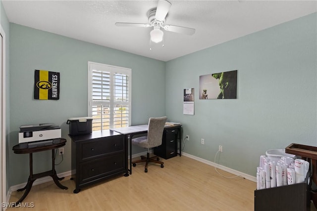 office featuring ceiling fan, light wood finished floors, and baseboards