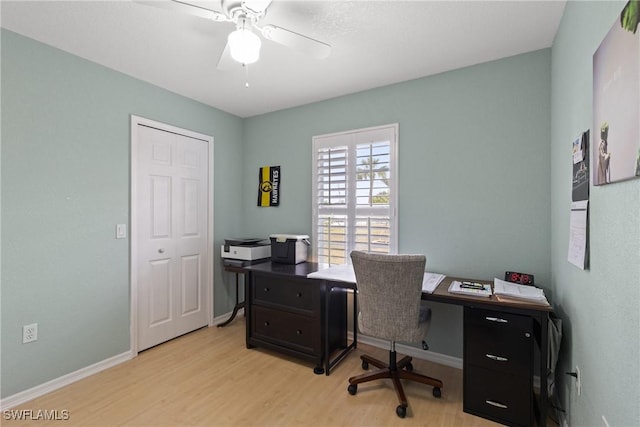 office with light wood-style flooring, baseboards, and ceiling fan