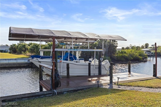 dock area featuring a lawn, a water view, and boat lift