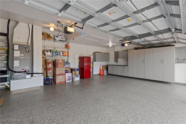 garage featuring electric panel and a garage door opener