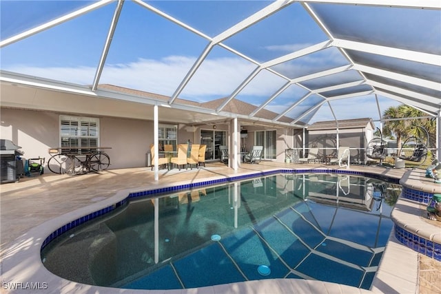 outdoor pool with a lanai and a patio