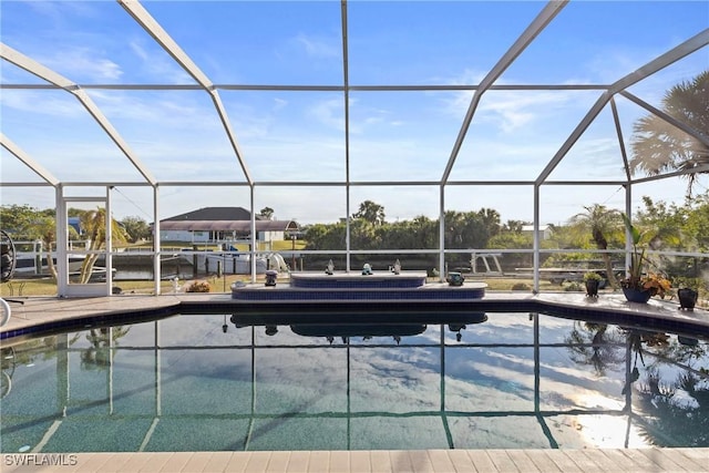 outdoor pool featuring glass enclosure