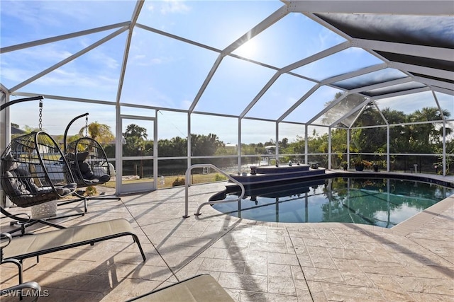 outdoor pool with a lanai and a patio