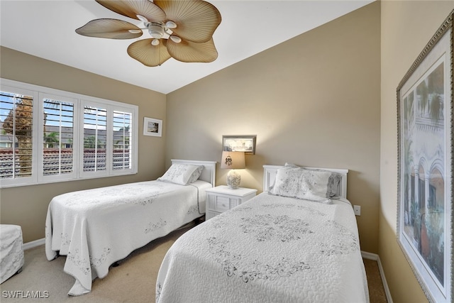 bedroom featuring lofted ceiling, light carpet, and ceiling fan