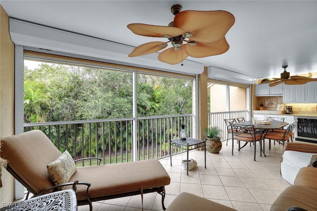 sunroom / solarium with ceiling fan and a healthy amount of sunlight