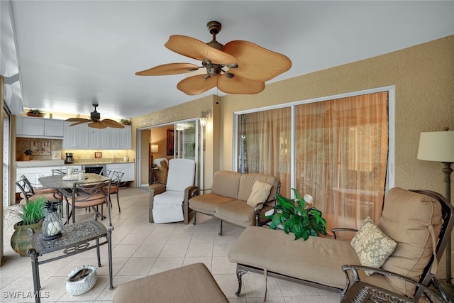 living room featuring light tile patterned floors and ceiling fan