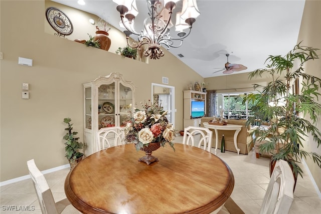 tiled dining space featuring high vaulted ceiling and ceiling fan with notable chandelier