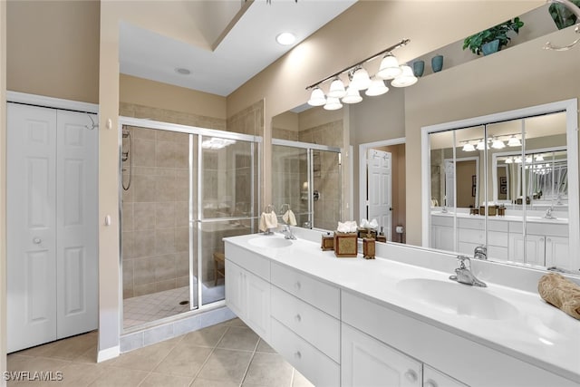 bathroom with walk in shower, tile patterned floors, and vanity