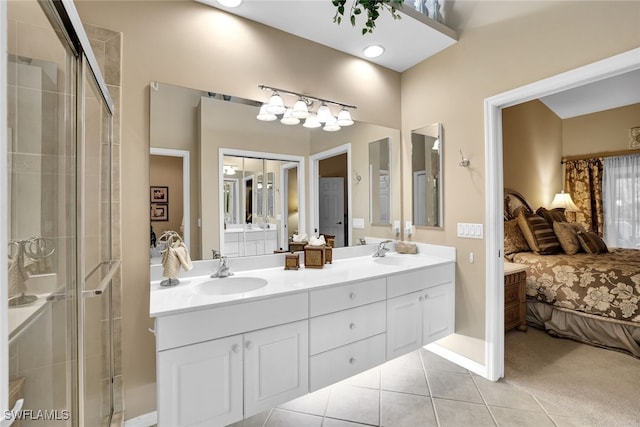 bathroom with walk in shower, vanity, and tile patterned flooring