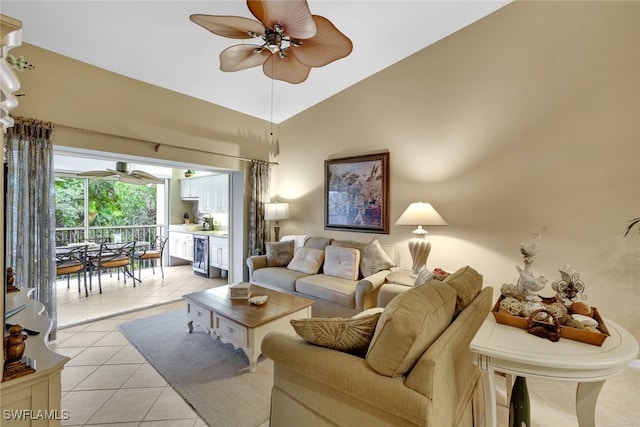 tiled living room featuring ceiling fan, lofted ceiling, and beverage cooler