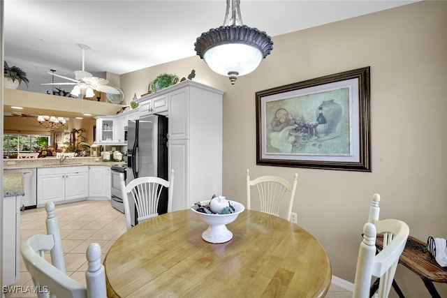 tiled dining room with sink and ceiling fan