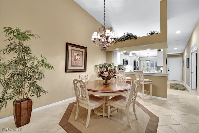 tiled dining space with a chandelier and a high ceiling