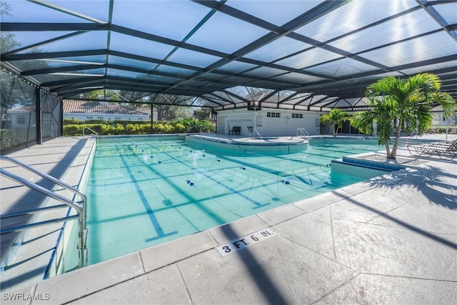 view of swimming pool featuring a lanai and a patio area