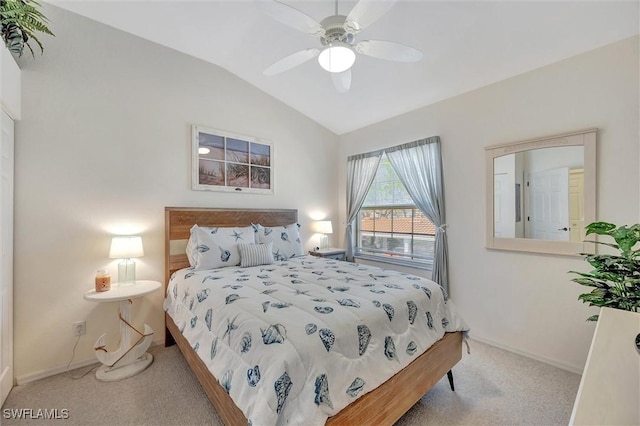 bedroom with vaulted ceiling, ceiling fan, and carpet floors