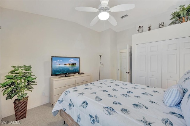 carpeted bedroom featuring vaulted ceiling, ceiling fan, and a closet