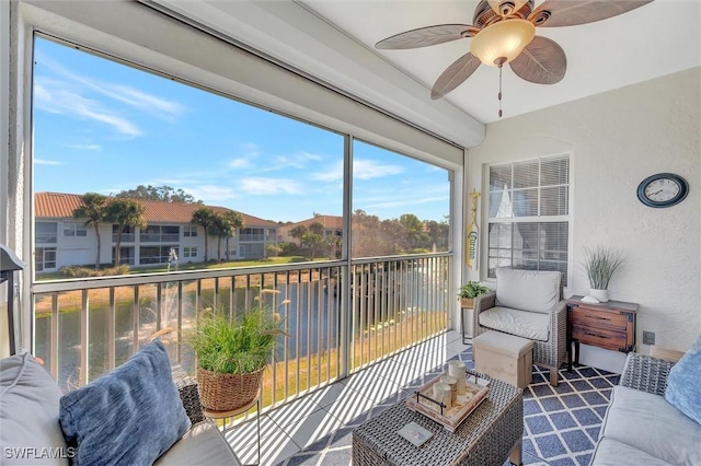 sunroom / solarium featuring ceiling fan