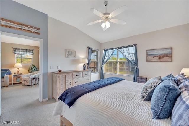 bedroom with vaulted ceiling, light colored carpet, and ceiling fan