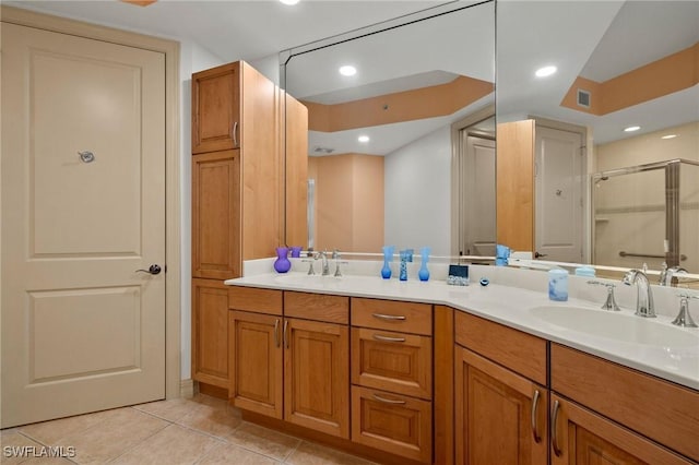 bathroom featuring vanity, tile patterned floors, and walk in shower