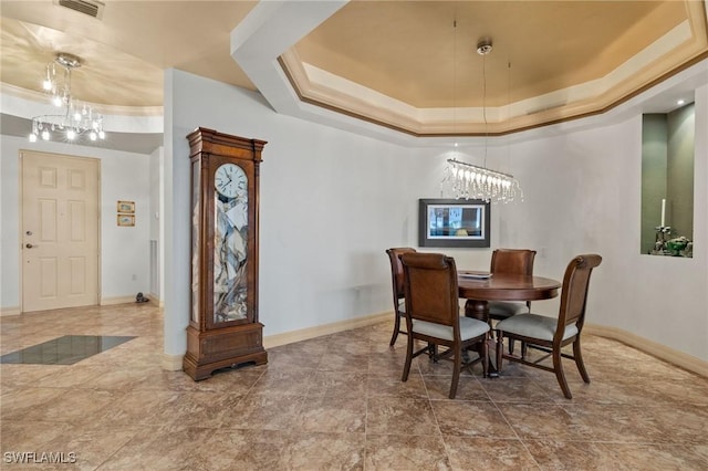 dining space featuring a raised ceiling, visible vents, and an inviting chandelier