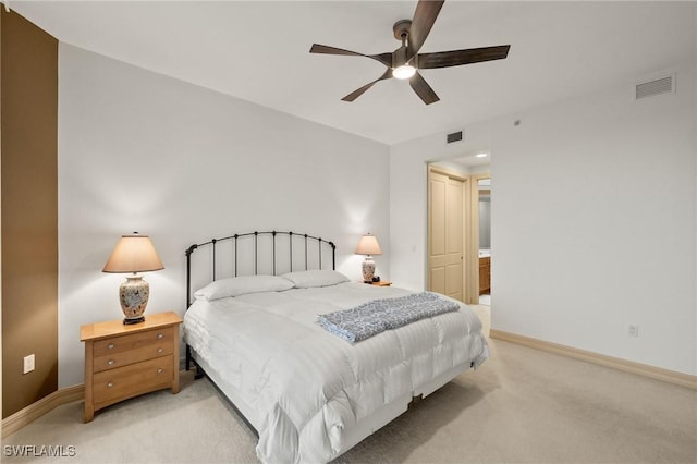 bedroom with light carpet, ceiling fan, visible vents, and baseboards