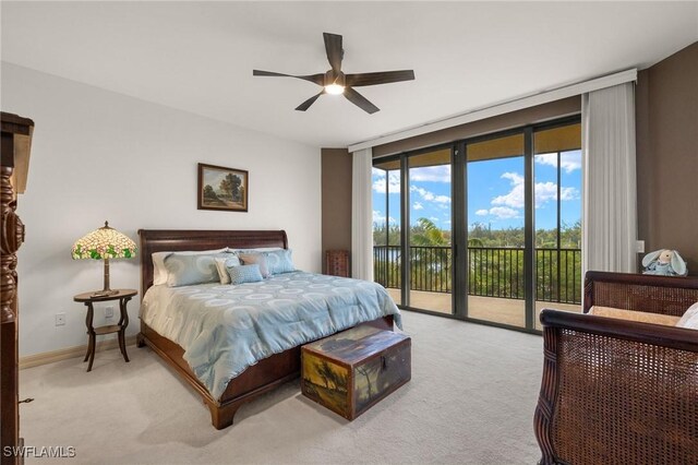 bedroom with expansive windows, ceiling fan, access to exterior, and light colored carpet