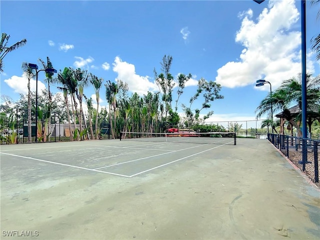 view of tennis court featuring fence