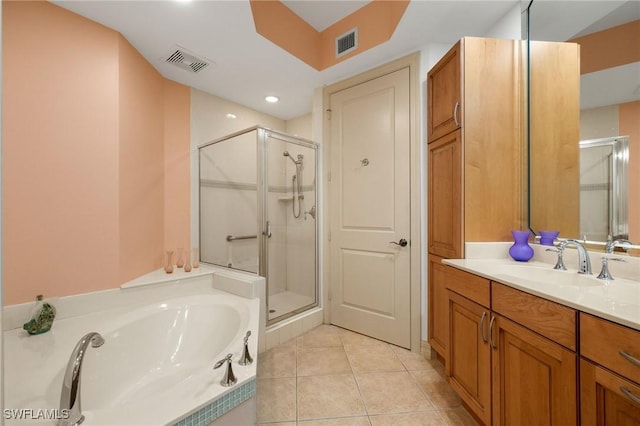 bathroom featuring tile patterned flooring, vanity, and plus walk in shower