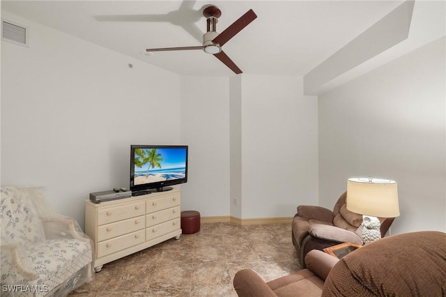 living room featuring baseboards, visible vents, and ceiling fan