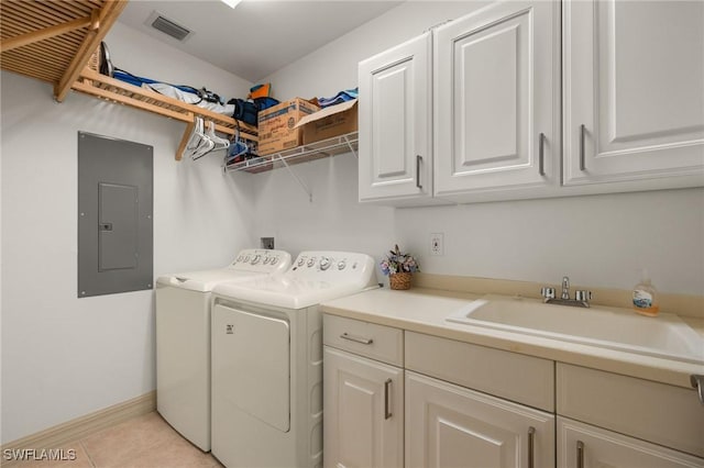 clothes washing area with cabinet space, electric panel, visible vents, washing machine and dryer, and a sink