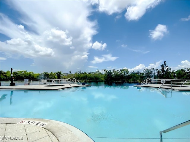 view of swimming pool with a water view