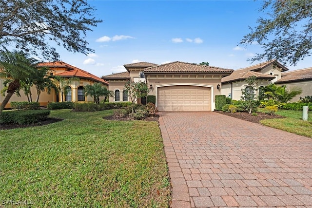 mediterranean / spanish house with a garage and a front yard