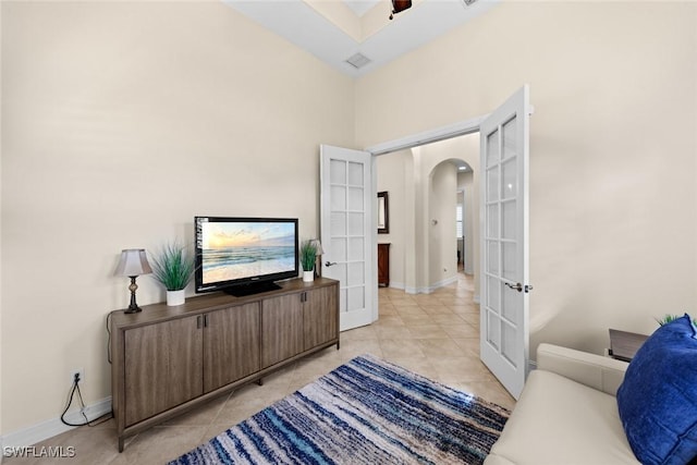 tiled living room featuring french doors