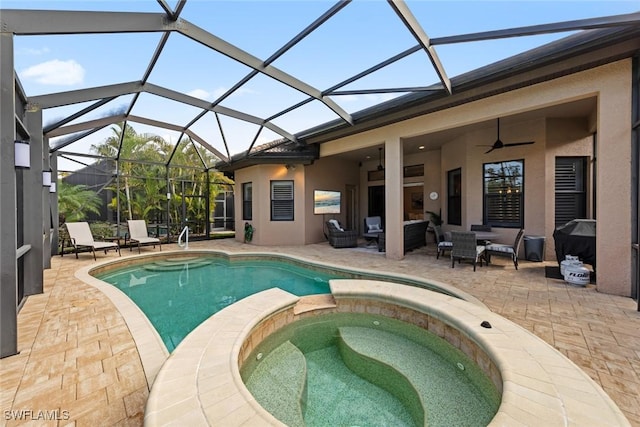 view of swimming pool with ceiling fan, glass enclosure, an outdoor living space, a patio area, and an in ground hot tub