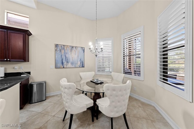 tiled dining space featuring an inviting chandelier