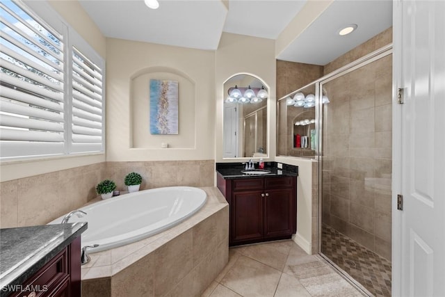 bathroom featuring vanity, independent shower and bath, and tile patterned flooring