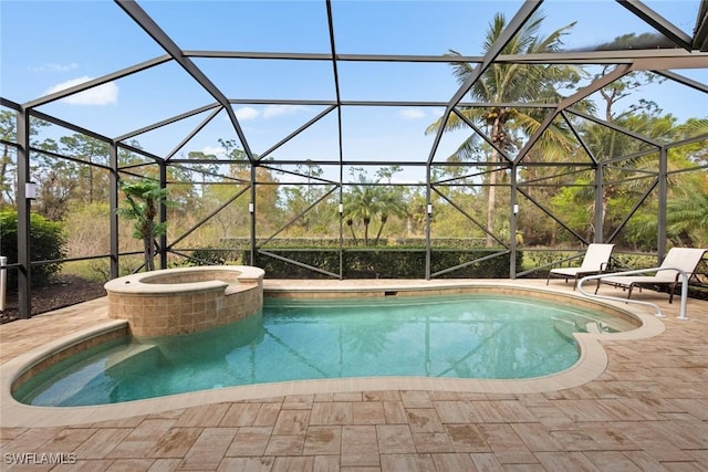 view of swimming pool featuring an in ground hot tub, a lanai, and a patio area