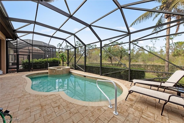 view of swimming pool featuring an in ground hot tub, a lanai, and a patio area