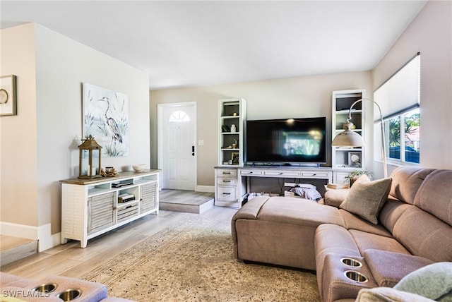 living room featuring baseboards and light wood finished floors