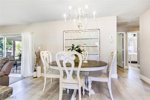 dining room with a notable chandelier and light hardwood / wood-style flooring