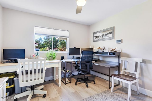 office with baseboards, light wood-style floors, and ceiling fan