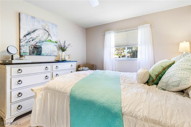 bedroom with a ceiling fan and light wood finished floors