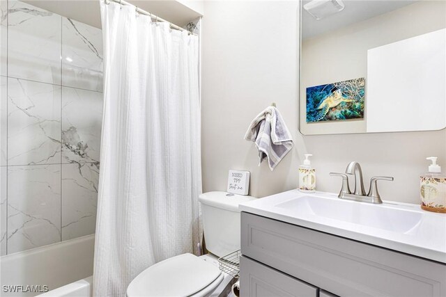 full bathroom with vanity, shower / bath combo, and toilet