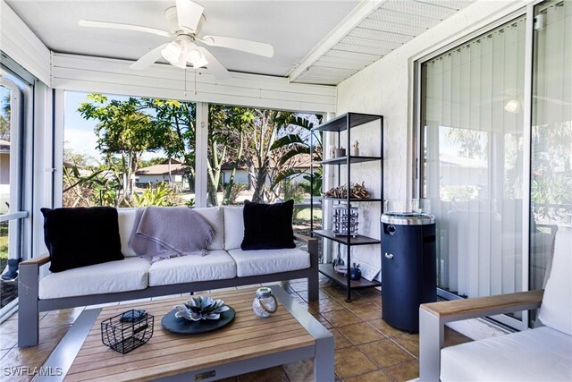 sunroom / solarium featuring ceiling fan