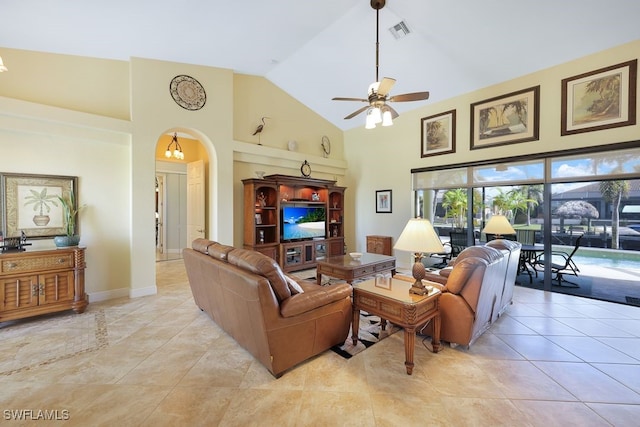 tiled living room featuring ceiling fan and high vaulted ceiling