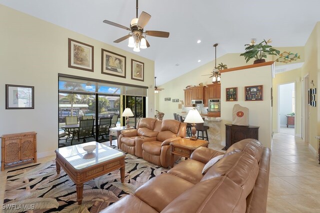 living room featuring high vaulted ceiling, light tile patterned flooring, and ceiling fan