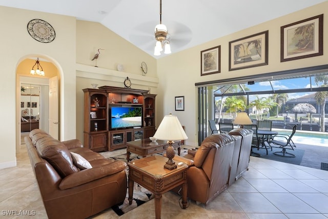 living room featuring ceiling fan, light tile patterned floors, and high vaulted ceiling